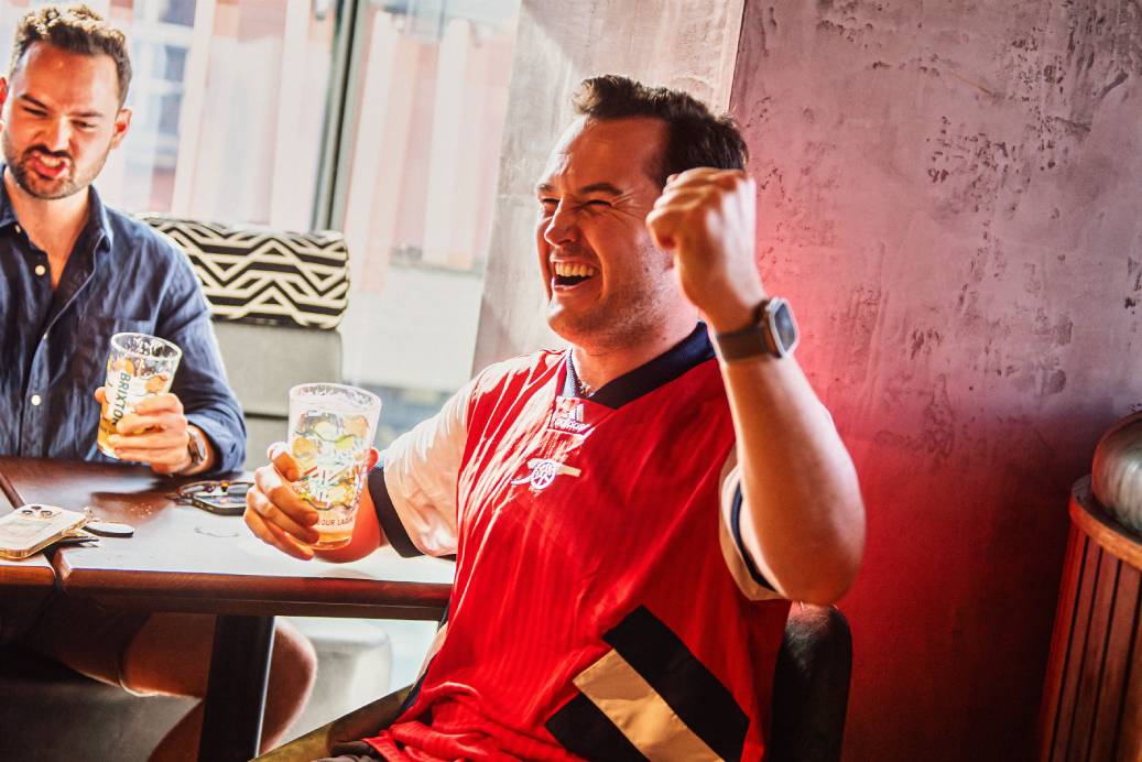 Football fan celebrates goal at Ludo